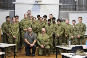 Group photo of military trainees and instructors in uniform.