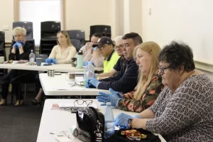 Participants in a workshop seated at a table, engaged in discussion.