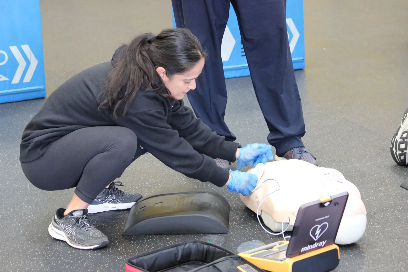 Individual practicing CPR techniques on a training mannequin.