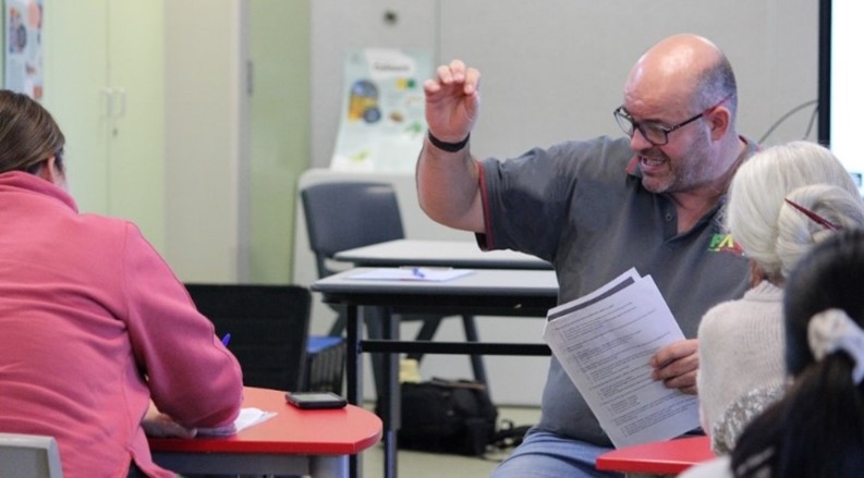 A teacher engaging students during a classroom discussion.