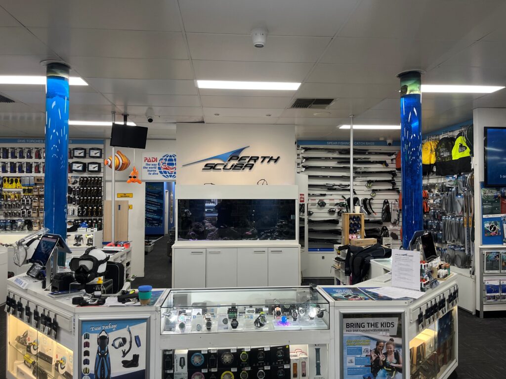 Interior of a scuba shop showcasing diving equipment and displays.