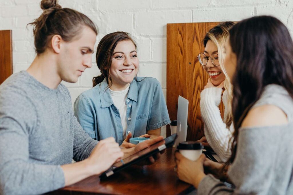 Group of friends engaged in conversation at a café table.