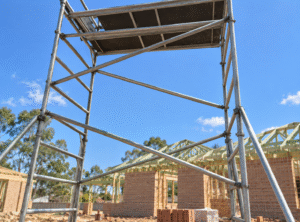 Scaffolding detail with a digitally replaced housing construction background.
